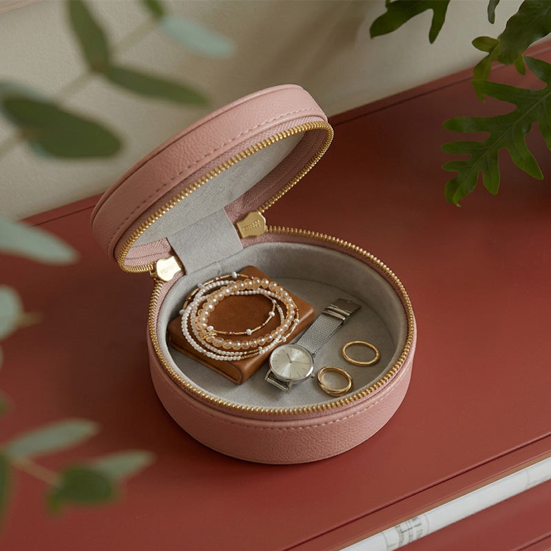 Round vegetable tanned leather jewelry box with velvet lining, open flat view — travel case for rings and earrings.