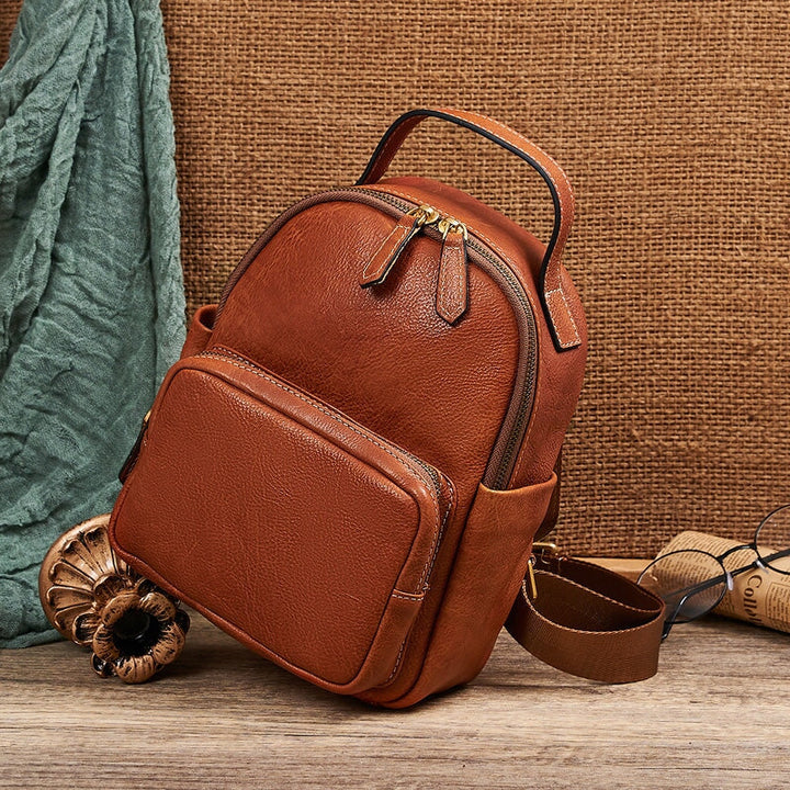 Small vintage leather backpack for women in cognac brown with brass zipper and front pocket