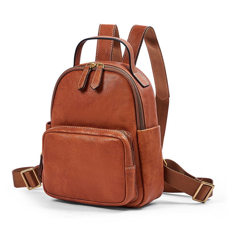 Small vintage leather backpack for women in cognac brown with brass zipper and front pocket