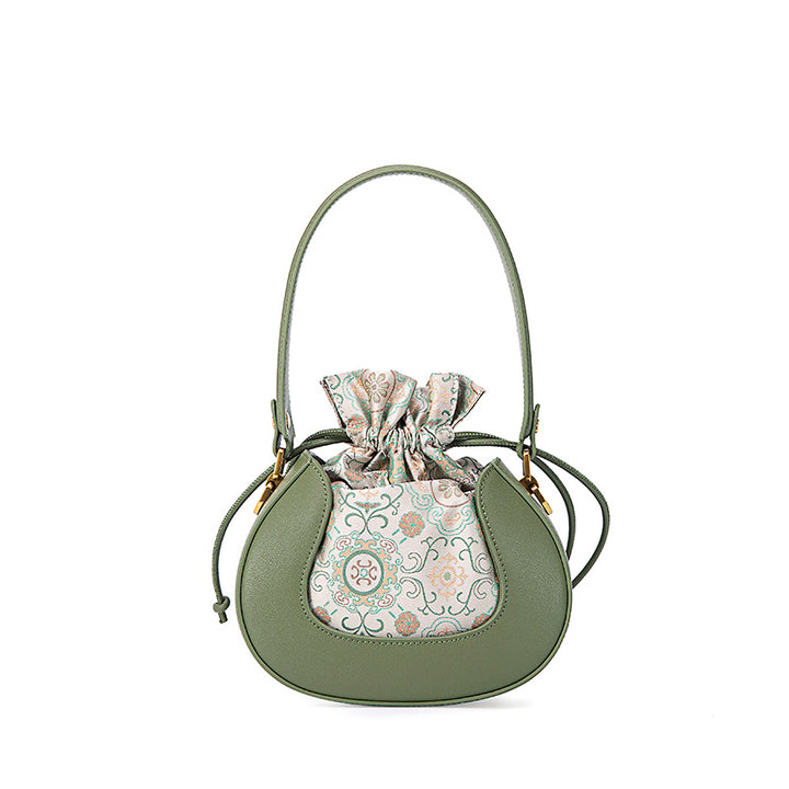 Green Song brocade silk bucket bag with floral pattern and leather trim, shown front view