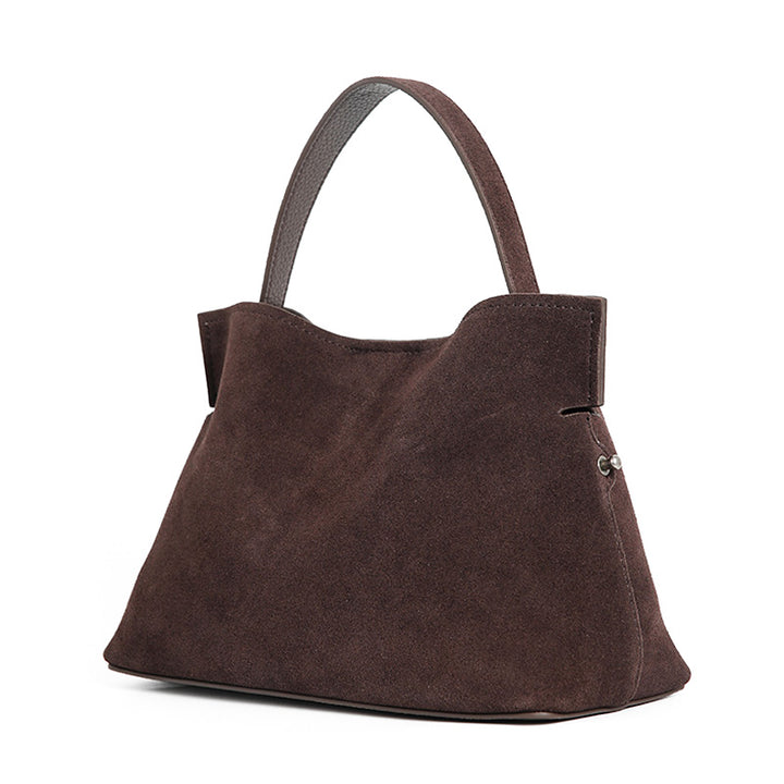 Coffee suede slouchy shoulder bag with adjustable strap, worn crossbody
