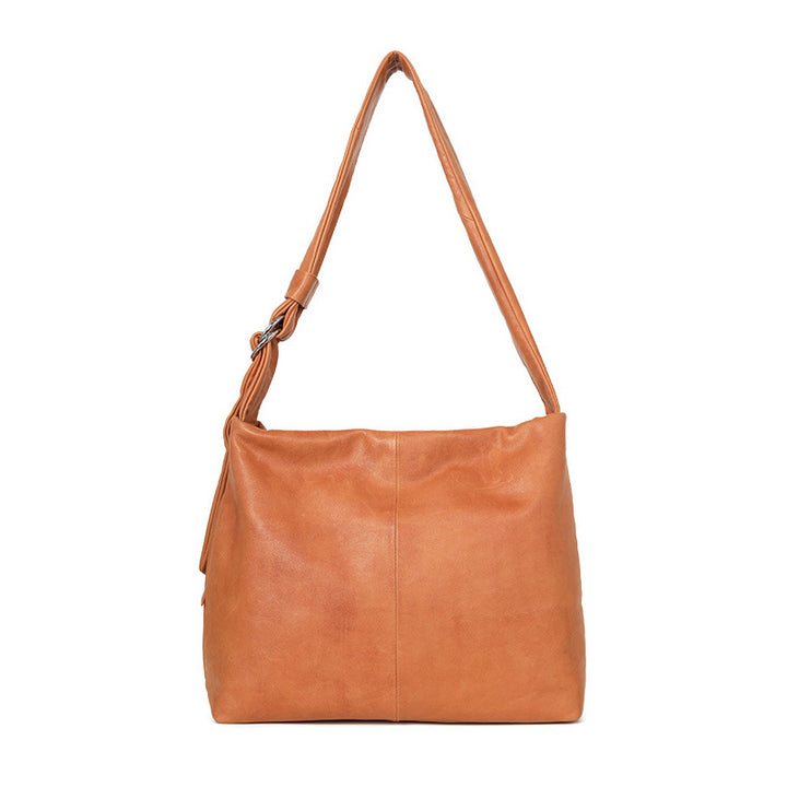 Top grain leather hobo bag in orange with a slouchy silhouette and adjustable shoulder strap