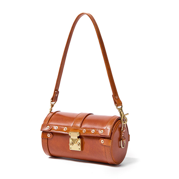 Vegetable tanned cowhide leather barrel bag in cognac brown with metal latch lock and dual detachable straps