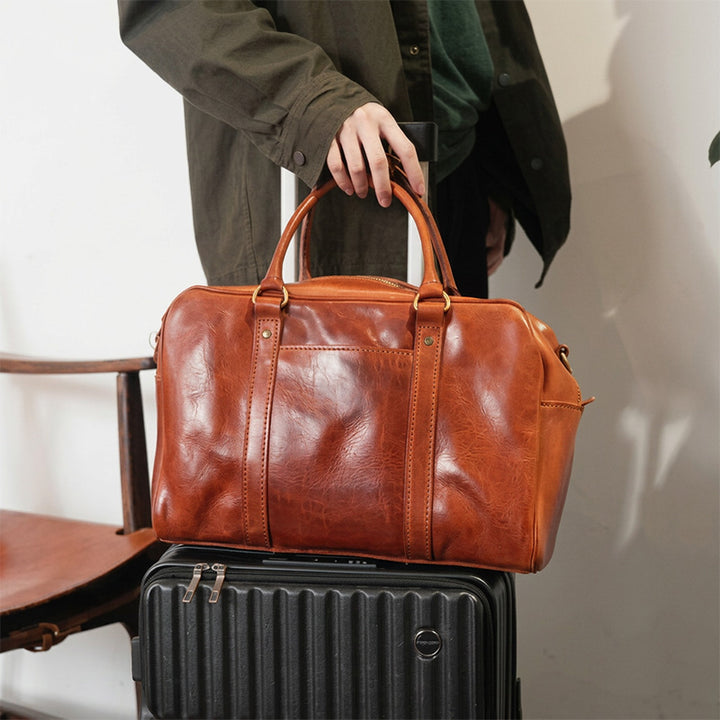 Honey brown vegetable-tanned leather Boston bag with laptop compartment and detachable shoulder strap