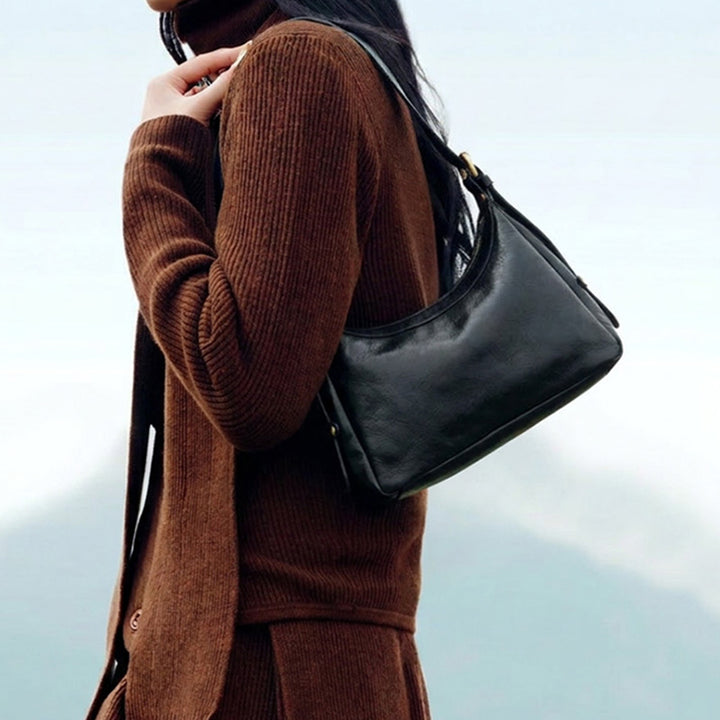 Vegetable tanned leather hobo bag in crescent silhouette with zip closure and adjustable shoulder strap