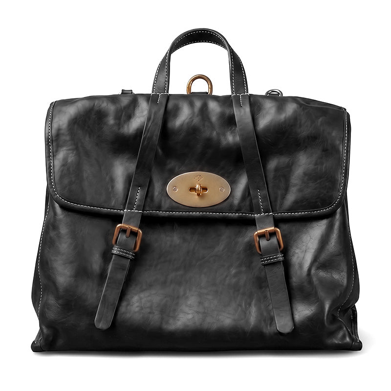 Vintage vegetable tanned leather backpack with flap lock closure and gold hardware, shown in black