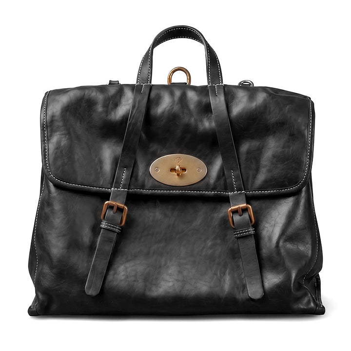 Vintage vegetable tanned leather backpack with flap lock closure and gold hardware, shown in black