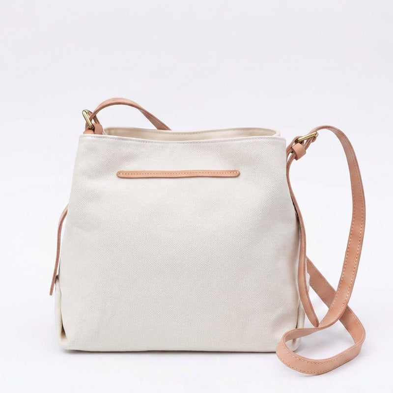 White canvas shoulder bag with genuine leather straps.