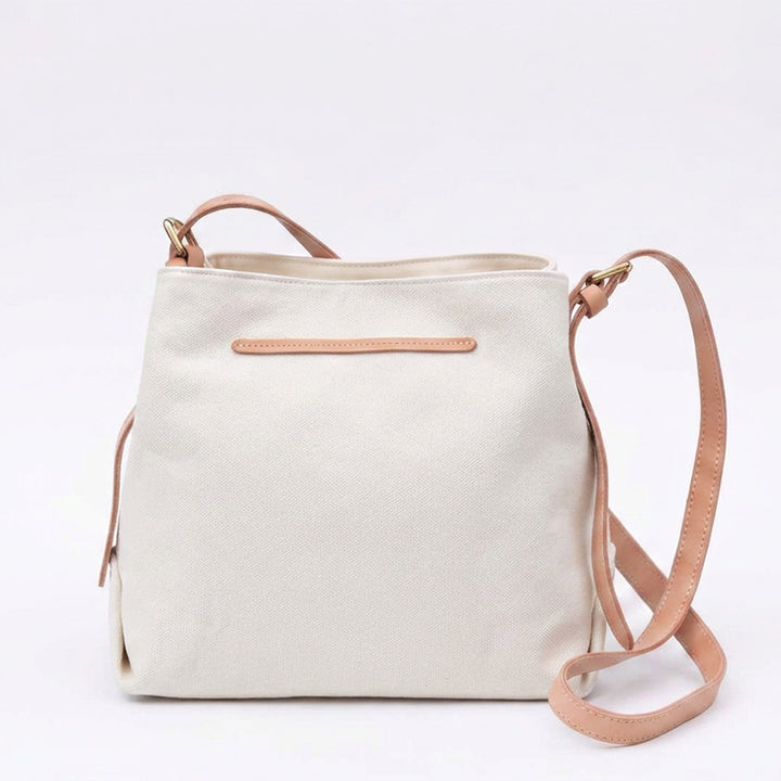 White canvas shoulder bag with genuine leather straps.
