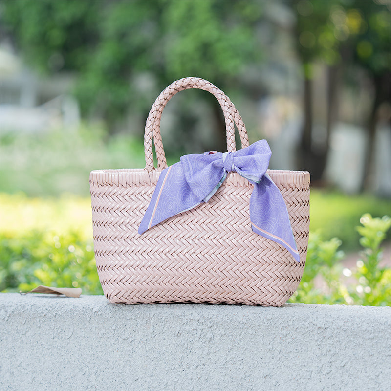 Handmade woven leather basket bag in pink with cowhide weave and top handles