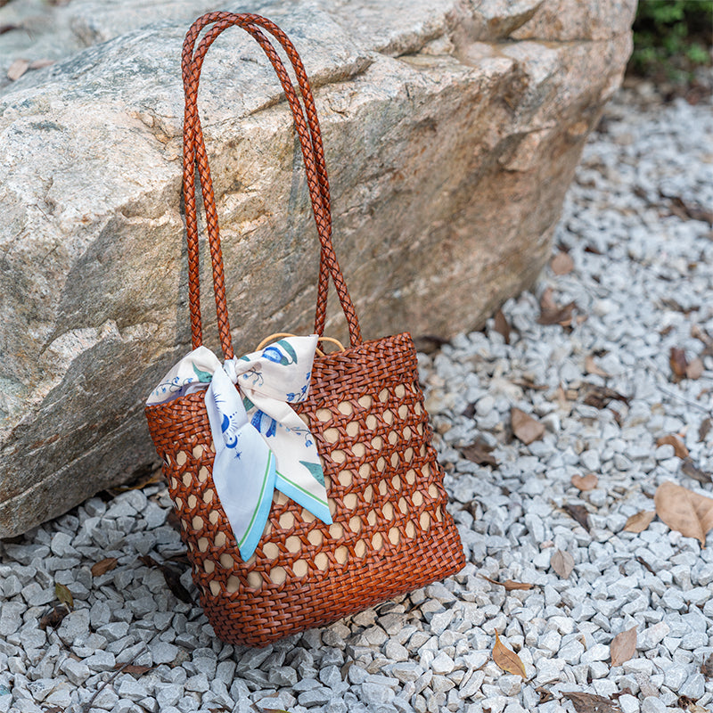 Handmade woven leather bucket bag in brown cowhide with drawstring closure