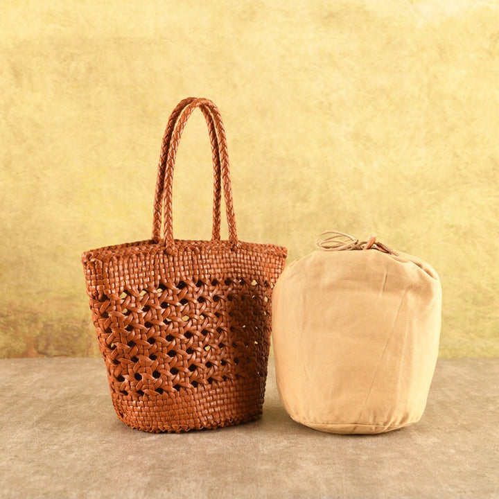 Handmade woven leather tote bag in cognac brown with hollow lattice weave and removable inner pouch