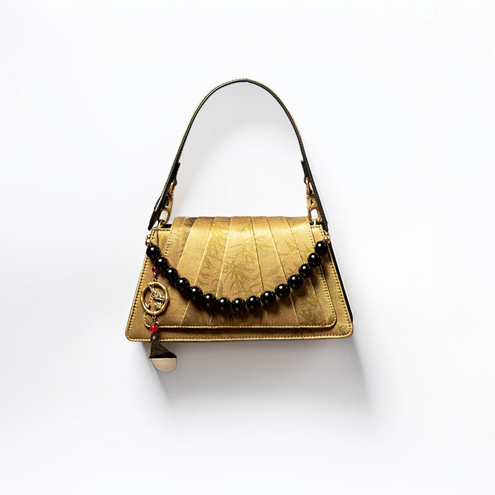 Xiangyunsha silk fan-pleated top handle bag in gold with ink bamboo motif and black beaded handle