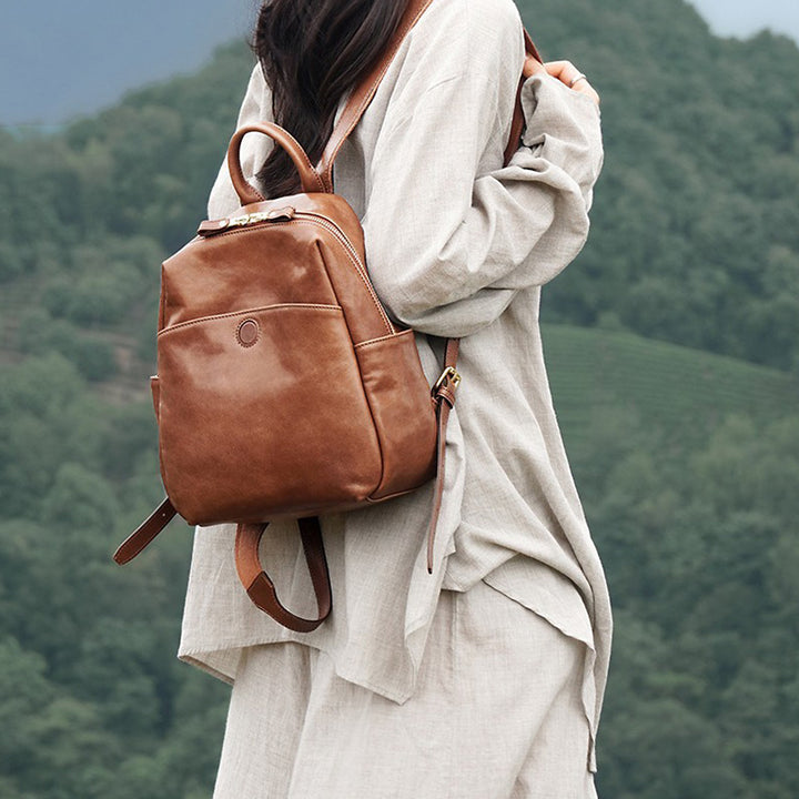 Yellow full grain vegetable tanned leather backpack with minimalist silhouette and adjustable straps